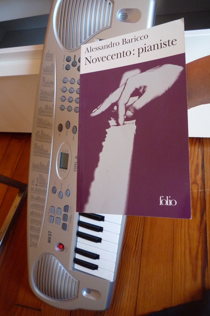 Un livre présentant un piano sur la première de couverture est présenté au premier plan, au dessus d'un piano électrique. Les deux images se superposent pour créer un effet  d'inclusion. 